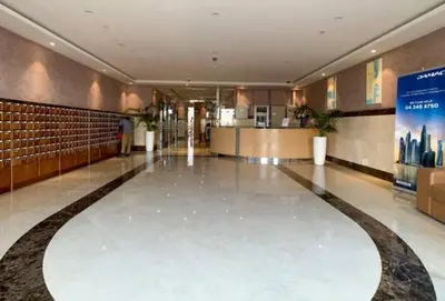 a lobby of a building with a large tile floor at Cozy Furnished Studio in Dubai