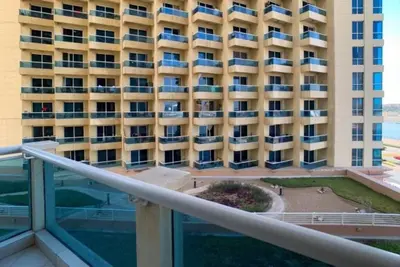 a view of a large building from a balcony at Cozy Furnished Studio in Dubai