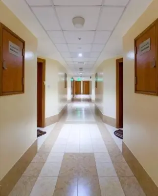 an empty hallway in an office building with ailed floor at Cozy Furnished Studio in Dubai