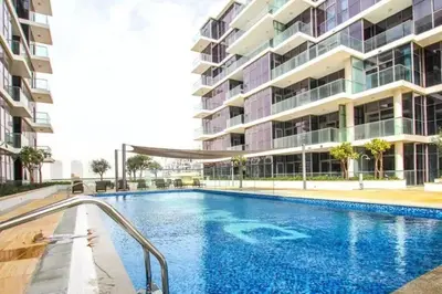 a swimming pool in front of a building at Furnished Cozy Studio in Dubai