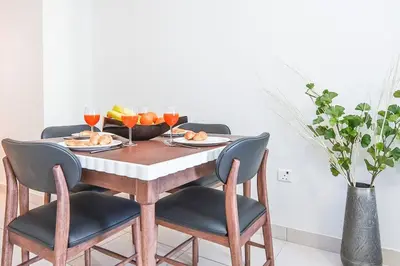 a table with a bowl of fruit and wine glasses at FIRST CLASS 2BR with Exquisite Full Marina View in Dubai