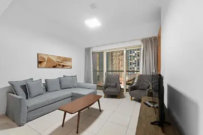 a living room with a couch and a table at FIRST CLASS 2BR with Exquisite Full Marina View in Dubai