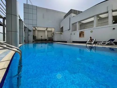 a large pool with blue water in a building at Stylish Studio Walk to Dubai Mall & Burj Khalifa with Pool, Gym & Balcony in Dubai