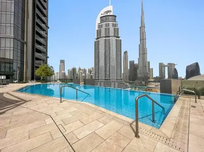 a swimming pool with a city skyline in the background at Modern 2BR with Harbor Views, Pool, & Concierge in Dubai