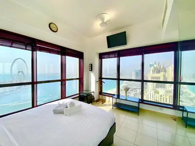 a bedroom with a bed with a view of the city at Amazing Sea View 2 bedroom Full Apartment in Dubai