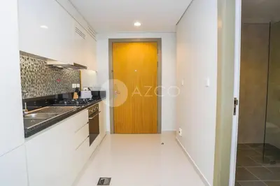 a kitchen with white walls and a wooden door at Elegant Studio at Aykon City Tower - C in Dubai