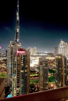 a view of a city at night with a tall building at The Signature Burj Khalifa View Residence with Terrace in Dubai