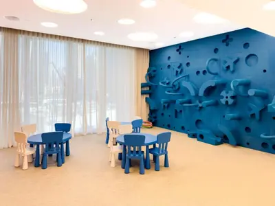 a room with blue tables and chairs and a blue wall at Charming Apartment in Downtown Just Steps from Burj Khalifa & Dubai Mall by Bhavan Vacation Homes in Dubai