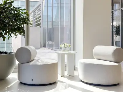 two white chairs sitting in a room with a window at Charming Apartment in Downtown Just Steps from Burj Khalifa & Dubai Mall by Bhavan Vacation Homes in Dubai