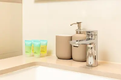 a bathroom with a sink and toiletries on a counter at Remarkable 2BR+storage in JBR with Sea View in Dubai