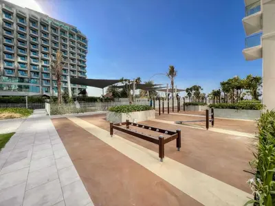 a park with benches in front of a building at Remarkable 2BR+storage in JBR with Sea View in Dubai