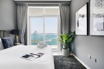 a bedroom with a white bed with a large window at Marina Skyline View & Dubai Harbour Beachfront in Dubai