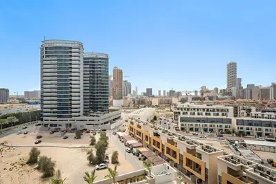 an aerial view of a city with tall buildings at Stunning modern 3BR apartment in JVC in Dubai
