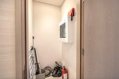 a room with a wall with a microwave and some tools at Elegant 1BR in Palm Tower, Nakheel Mall, Sea View in Dubai