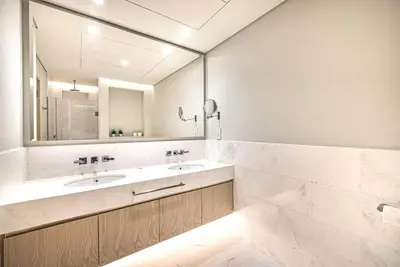 a bathroom with two sinks and a large mirror at Palm Tower Luxury Studio W Stunning Sea View in Dubai