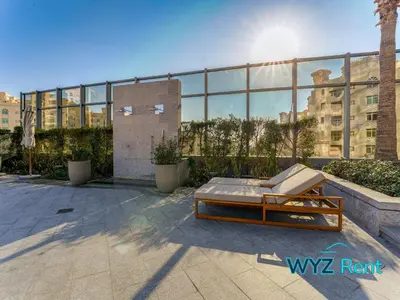 a bed on a patio in front of a building at Palm Tower Luxury Studio W Stunning Sea View in Dubai