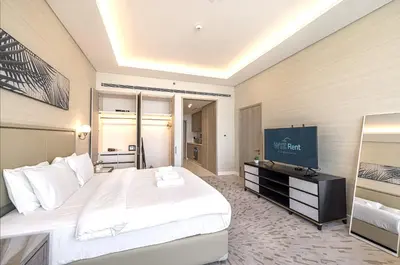 a hotel room with a large bed and a flat screen tv at Palm Tower Luxury Studio W Stunning Sea View in Dubai