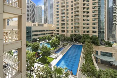 an overhead view of a pool in a city with tall buildings at Silkhaus Modern Studio Near Burj Khalifa in Dubai