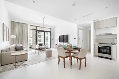a kitchen and living room with a table and chairs at Silkhaus Sea and City View 1BDR in Marina Vista in Dubai