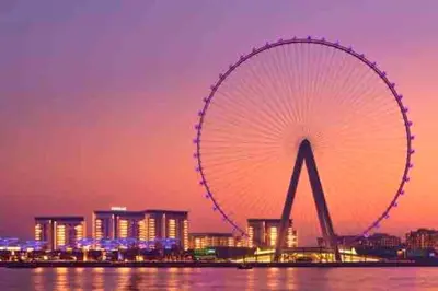 a large ferris wheel in a city at night at Your Scenic Dream Vacation in Dubai