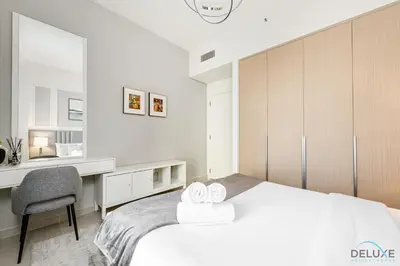 a bedroom with a bed and a desk and a chair at Lavish 1BR Apartment at Summer at Creek Beach, Dubai Creek Harbor by Deluxe Holiday Homes in Dubai