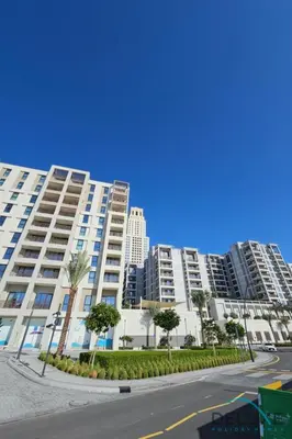 an empty street in front of a large apartment building at Lavish 1BR Apartment at Summer at Creek Beach, Dubai Creek Harbor by Deluxe Holiday Homes in Dubai