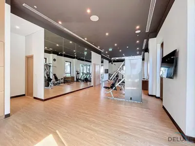 a gym with treadmills and ellipticals in a building at Lavish 1BR Apartment at Summer at Creek Beach, Dubai Creek Harbor by Deluxe Holiday Homes in Dubai