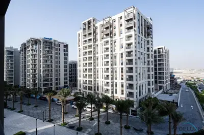 two tall white buildings in a city with palm trees at Lavish 1BR Apartment at Summer at Creek Beach, Dubai Creek Harbor by Deluxe Holiday Homes in Dubai
