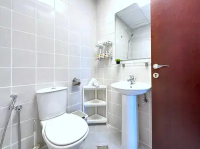 a bathroom with a toilet and a sink at Lxury Brand New Studio w/ Balcony and Marina View in Dubai