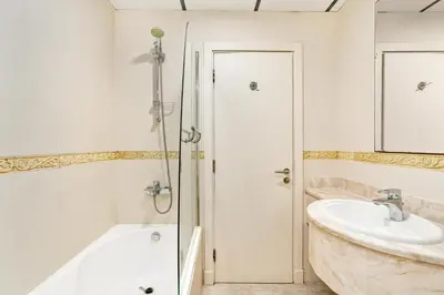 a bathroom with a tub and a sink at Ahlan HH - Princess Tower - Elegant 1BR in Dubai Marina in Dubai