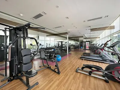 a gym with a lot of treadmills and machines at StoneTree - Furnished 1 BR - Glitz 3 in Dubai