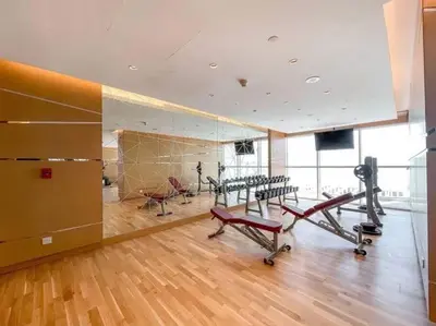 a gym with treadmills and machines in a room at StoneTree - Modern Studio - Carson A in Dubai