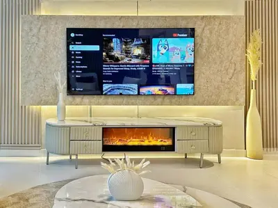 a living room with a tv and a fireplace at Your Private Beach Sunny Retreat in Dubai