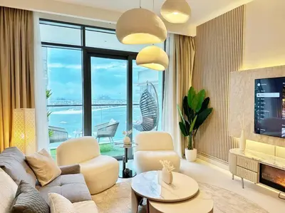 a living room with a couch and chairs and a large window at Your Private Beach Sunny Retreat in Dubai