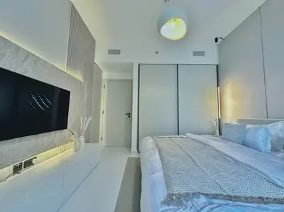 a bedroom with a large bed and a flat screen tv at Your Private Beach Sunny Retreat in Dubai
