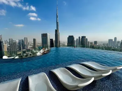 a infinity pool on the roof of a building with a city at High Floor Burj Khalifa & Sea View with stunning Infinity Pool in Dubai