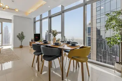 a dining room with a table and chairs at High Floor Burj Khalifa & Sea View with stunning Infinity Pool in Dubai