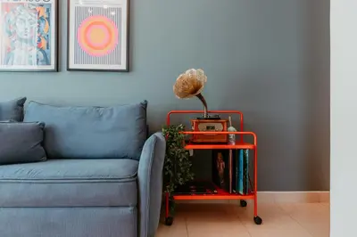 a living room with a blue couch and a red table at Stylish 2-Bedroom Escape near Dubai Mall in Dubai