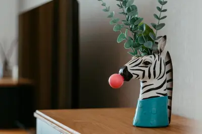a zebra vase with a ball in its mouth at Stylish 2-Bedroom Escape near Dubai Mall in Dubai