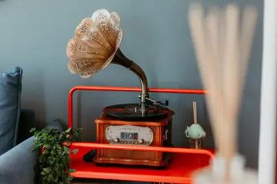 a lamp on a table with a clock and a fan at Stylish 2-Bedroom Escape near Dubai Mall in Dubai