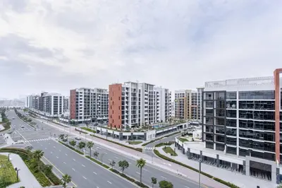 an empty street in a city with tall buildings at Tranquil Studio Retreat in Azizi 34 Near Downtown in Dubai