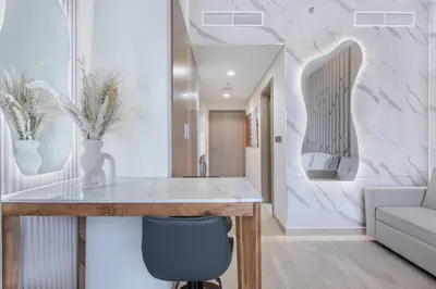 a kitchen with a table and a chair at Tranquil Studio Retreat in Azizi 34 Near Downtown in Dubai