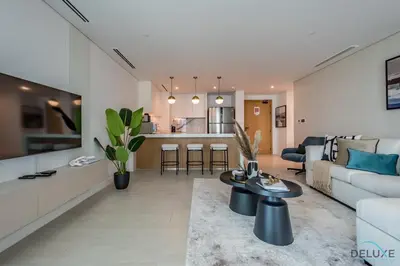 a living room with a couch and a table at Elegant 2BR Apartment in La Vie, JBR by Deluxe Holiday Homes in Dubai