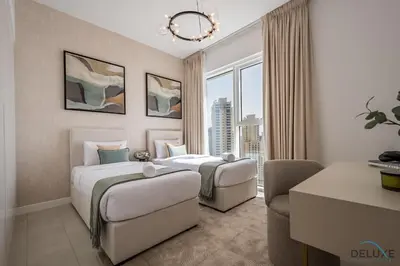two beds in a hotel room with a window at Elegant 2BR Apartment in La Vie, JBR by Deluxe Holiday Homes in Dubai