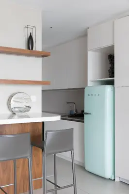 a kitchen with white cabinets and a refrigerator at Fabulous 1BR apartment in Address Beach Resort in Dubai