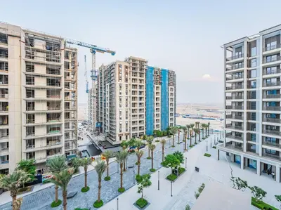an overhead view of a street with palm trees and buildings at Creek Beachfront Heaven: 1BR Luxe Harbor Flat in Dubai