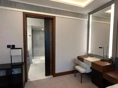 a bathroom with a mirror and a sink and a desk at Bluewaters Island - Modern 2 bedroom Full Apartment in Dubai