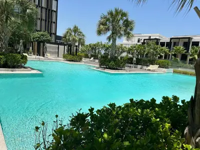 a large pool with blue water in a building at Bluewaters Island - Modern 2 bedroom Full Apartment in Dubai