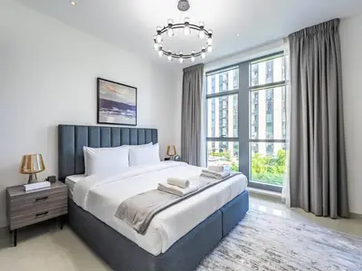 a bedroom with a large bed and a chandelier at Modern Downtown Escape 1Bedroom with Upscale Comfort in Dubai