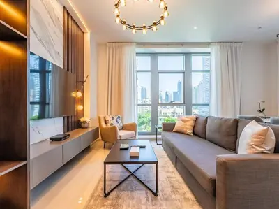a living room with a couch and a table at Modern Downtown Escape 1Bedroom with Upscale Comfort in Dubai